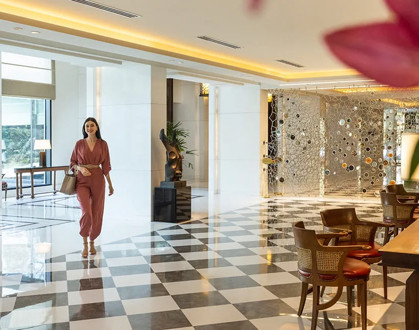 Woman walking through lobby of The Oberoi, New Delhi. Woman walking through lobby of The Oberoi, New Delhi.